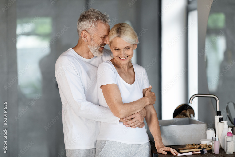 Portrait Of Happy Mature Spouses Embracing In Bathroom Interior Portrait Of Happy Mature Spouses Embracing In Bathroom Interior