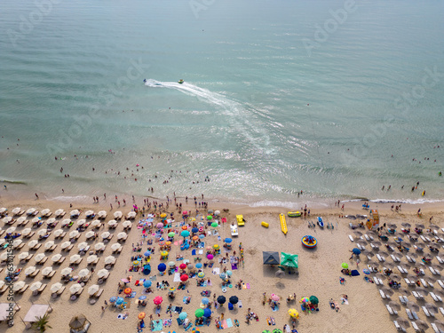 aerial view of Bulgaria's Kranevo resort during the summer season: an array of hotels, pools, and crowds of people enjoying the sea. photo