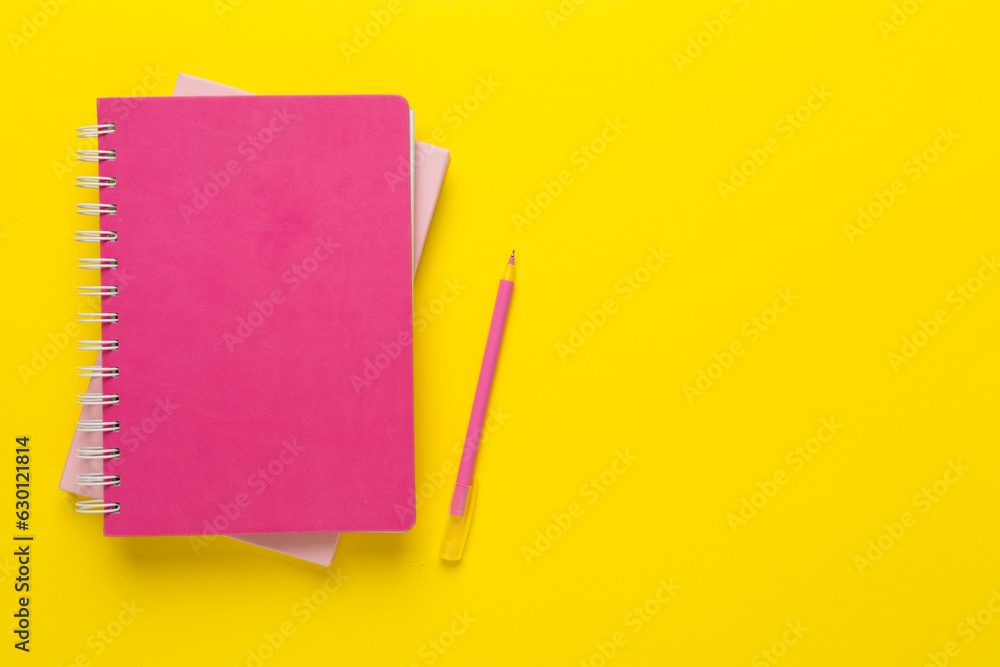 Notebooks with stationery on color background, top view Notebooks with stationery on color background, top view