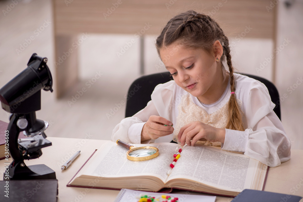 Small girl in drugs synthesis concept in the classroom Small girl in drugs synthesis concept in the classroom