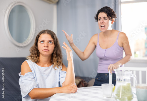 Homosexual couple of lesbian women quarrel at home on bed