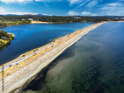 Aerial Esquimalt Lagoon sand spit overlooking Royal Roads University with a long straight road in Victoria British Columbia Canada. photo