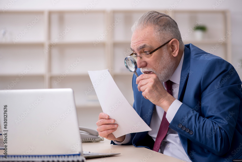 Old male employee and too much work at workplace Old male employee and too much work at workplace
