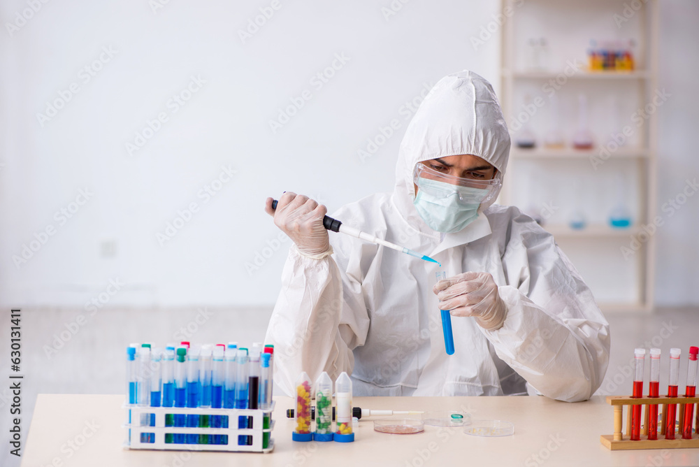 Young male chemist in drugs synthesis concept Young male chemist in drugs synthesis concept