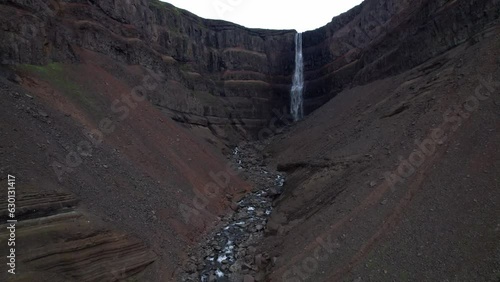 AERIAL VIEW Hengifoss is a waterfall that runs from the river Hengifossá in the municipality of Fljótsdalshreppur in East Iceland. At 128 metres (420 feet) it is the third tallest waterfall in Iceland photo