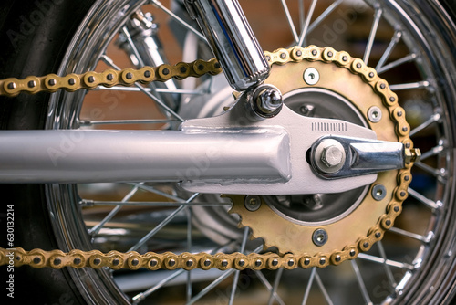 Close-up of a motorcycle chain and wheel