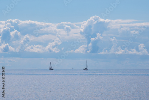 Lifeguard skiffs on an empty beach at morning with puffy white clouds in the background. room for text