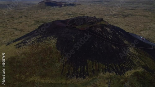 DRONE AERIAL FOOTAGE: Saxholl is a 45 meter high volcanic, ovalshaped crater. It rises up from the moss-covered lavafields in Snaefellsjokull National Park on the Snaefellsnes peninsula West Iceland.  photo