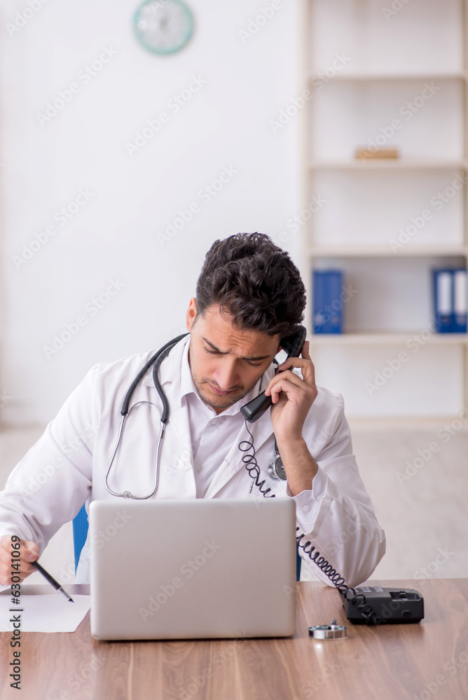 Young male doctor in telemedicine concept Young male doctor in telemedicine concept