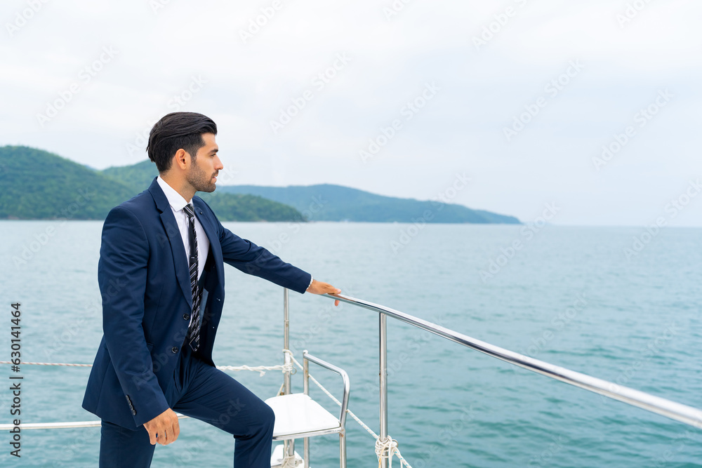 Portrait of Confidence Caucasian businessman relaxing with outdoor lifestyle for successful business travel nature ocean with sailing on luxury private catamaran boat yacht on summer holiday vacation. Portrait of Confidence Caucasian businessman relaxing with outdoor lifestyle for successful business travel nature ocean with sailing on luxury private catamaran boat yacht on summer holiday vacation.