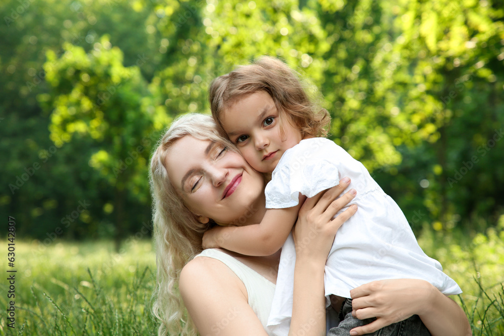 Portrait of beautiful mother with her cute daughter outdoors Portrait of beautiful mother with her cute daughter outdoors