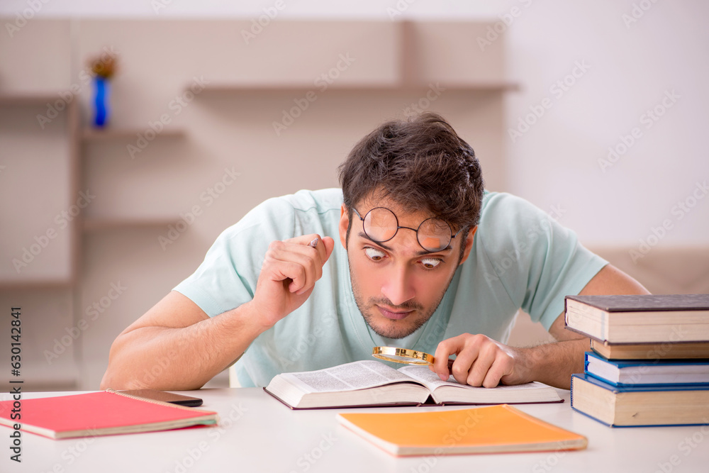 Young male student preparing for exams at home Young male student preparing for exams at home