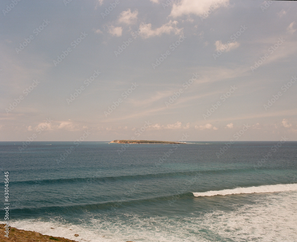 Distant Tropical Island Behind Waves