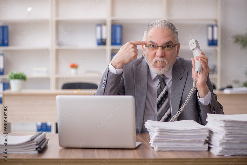 Old male employee and too much work in the office Old male employee and too much work in the office