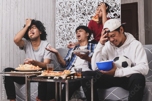 Multiracial friends watching football team losing the games photo