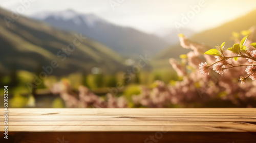 Empty wooden table top with blurred spring sunny mountains