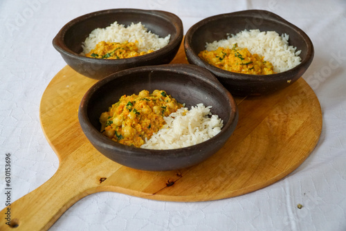 Three delicious chickpeas curry with white rice in beautiful ceramic bowls. Vegetarian food alterantives.