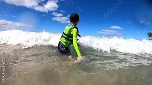 GoPro Video Of A Boy Smiling, Laughing, And Having Fun At The Beach. photo