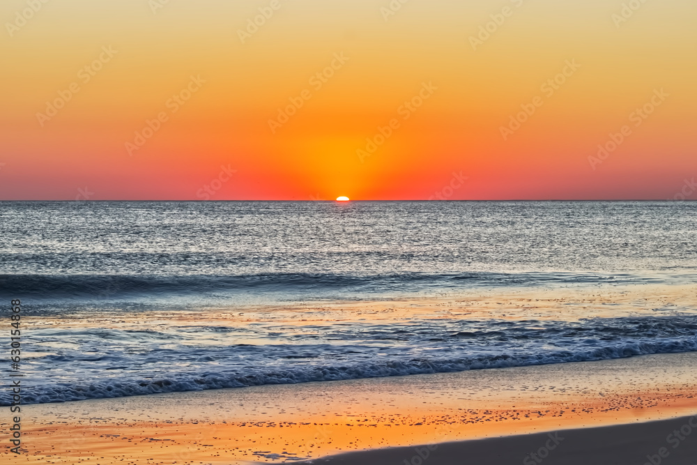 The sun, slowly emerging at the horizon - Outer banks, NC, USA