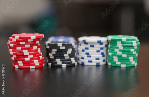 High-stakes Texas Hold'em poker chips and cards symbolize risk, chance, and adrenaline in gambling at the casino. Bet for fortunes