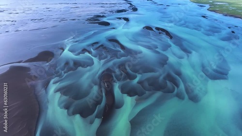 Drone shot tilting over teal colored texture on the Olfusa river in Iceland photo