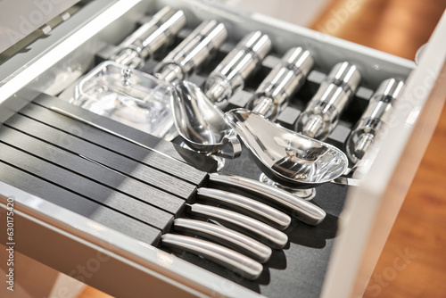 Kitchen utensil cutlery drawer organizer tray with simple set of tools, minimalist order. Order in kitchen. Kitchen furniture store.