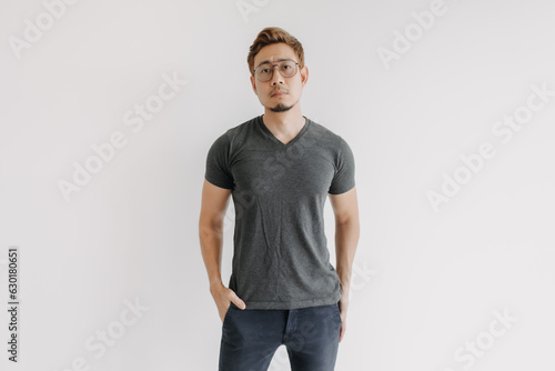 Cool and serious colored hair Asian man in black t-shirt isolated on white.
