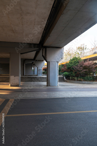 Concrete structure and asphalt road space under the overpass in the city