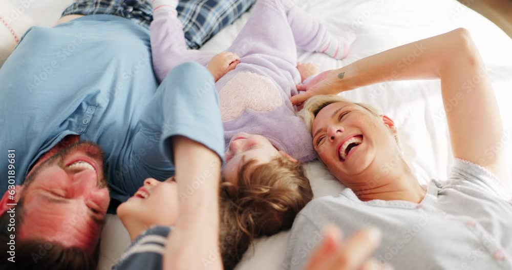 Parents, children and playing on bed in top view with bonding, comic laugh and funny game in family home. Mother, dad and young kids with quality time, tickling and happy together in bedroom at house Parents, children and playing on bed in top view with bonding, comic laugh and funny game in family home. Mother, dad and young kids with quality time, tickling and happy together in bedroom at house