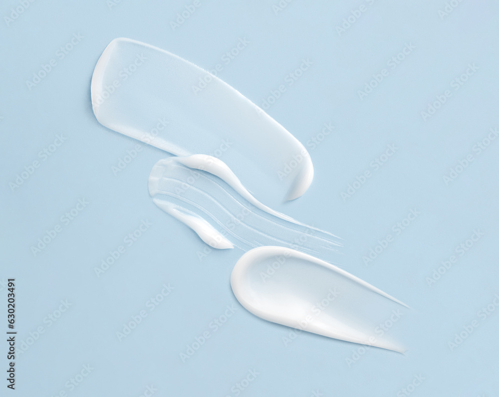 cosmetic smears cream texture on pastel blue background