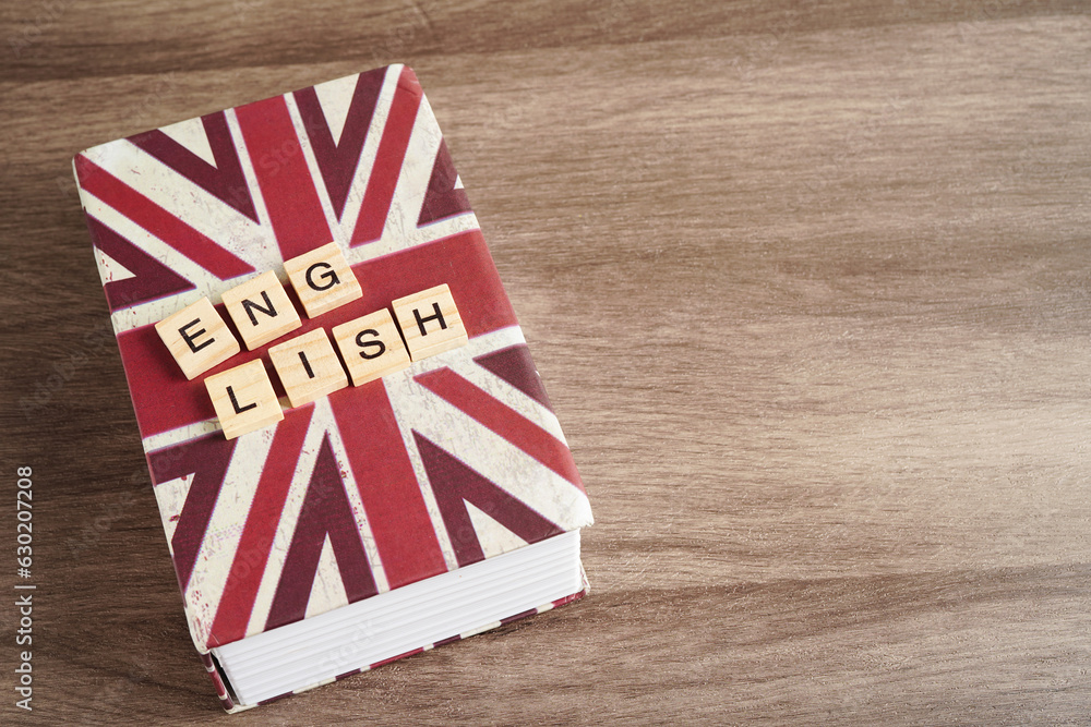 Fototapeta premium English book with graduate hat, learning and tutorial for foreigner.
