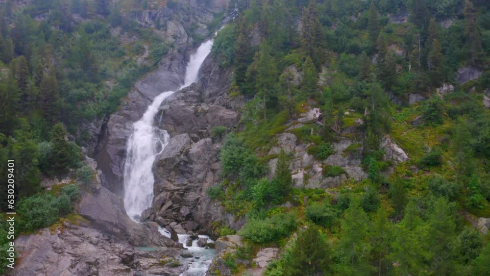 Travel over a small mountain river with rich alpine vegetation Travel over a small mountain river with rich alpine vegetation