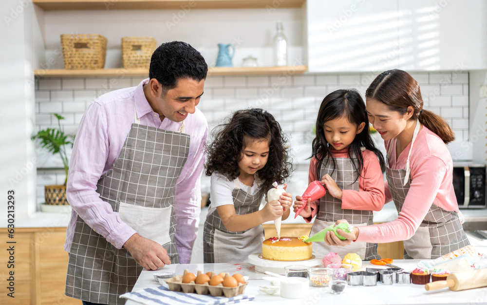 Portrait of enjoy happy love asian family father and mother with little asian girl daughter child play and having fun cooking food together with baking cookie and cake ingredient in kitchen Portrait of enjoy happy love asian family father and mother with little asian girl daughter child play and having fun cooking food together with baking cookie and cake ingredient in kitchen