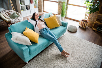 Top view photo of pretty lady sitting modern divan resting thinking about holidays in house indoors