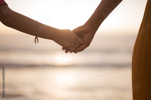 mother hand lead his child in summer beach nature outdoor, trust family concept