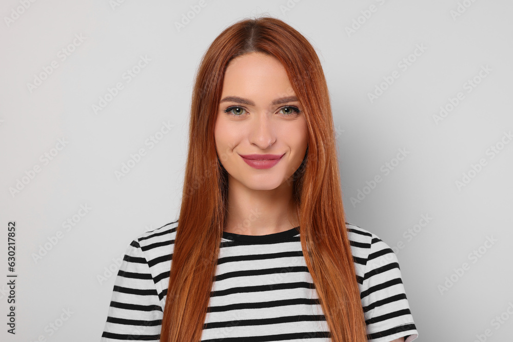 Portrait of beautiful young woman on light gray background Portrait of beautiful young woman on light gray background
