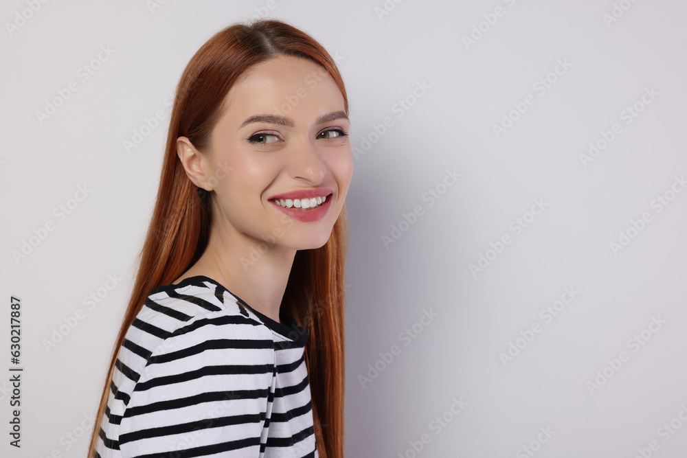 Portrait of beautiful young woman on light gray background, space for text Portrait of beautiful young woman on light gray background, space for text