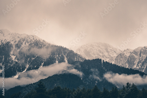 Beautiful winter landscape with snow covered trees and mountains in Kashmir. photo