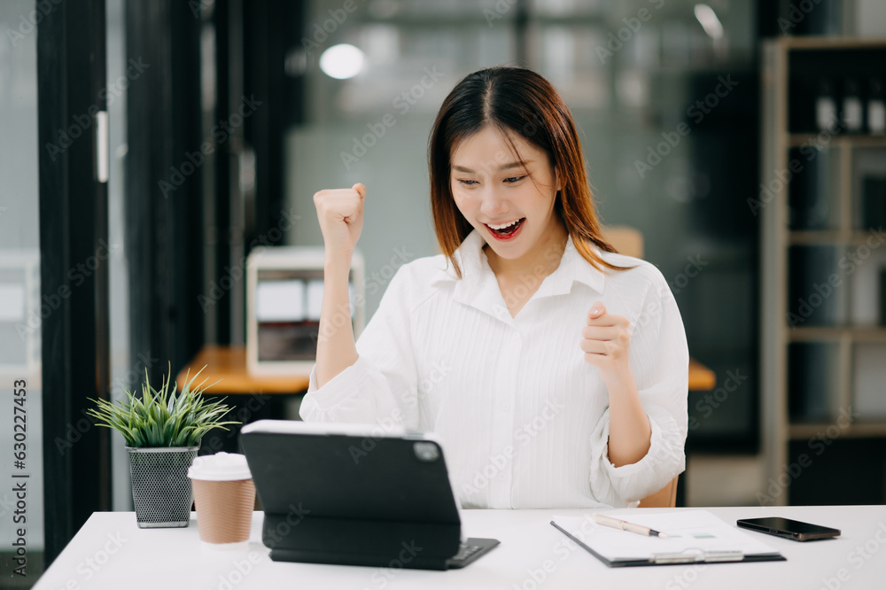 Asian business woman are delighted and happy with the work they do on their tablet, laptop and taking notes at office. Asian business woman are delighted and happy with the work they do on their tablet, laptop and taking notes at office.
