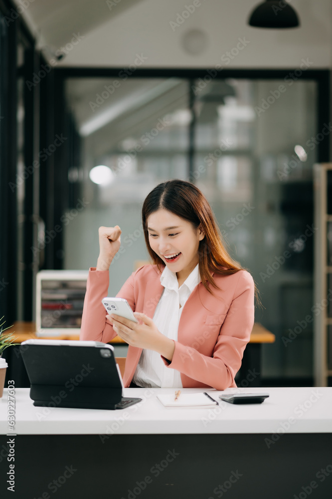Asian business woman are delighted and happy with the work they do on their tablet, laptop and taking notes at office. Asian business woman are delighted and happy with the work they do on their tablet, laptop and taking notes at office.