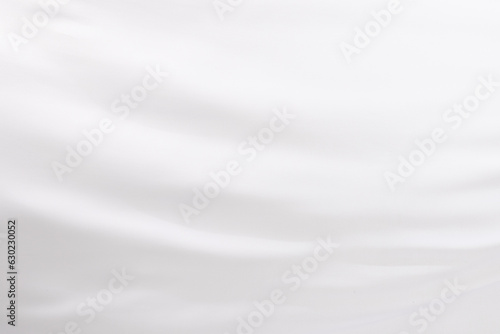 Close up of white shiny silk fabric with copy space background
