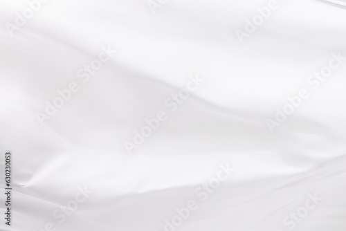 Close up of white shiny silk fabric with copy space background