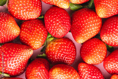 Close up of strawberries and copy space on pink background