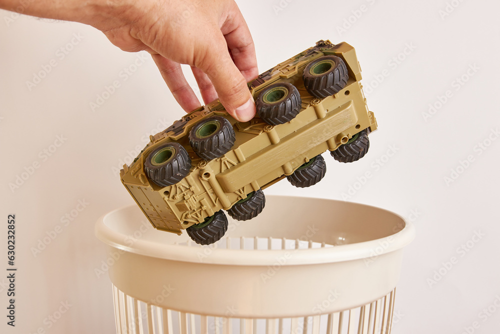 A broken children's toy is recycled and thrown into the trash. The