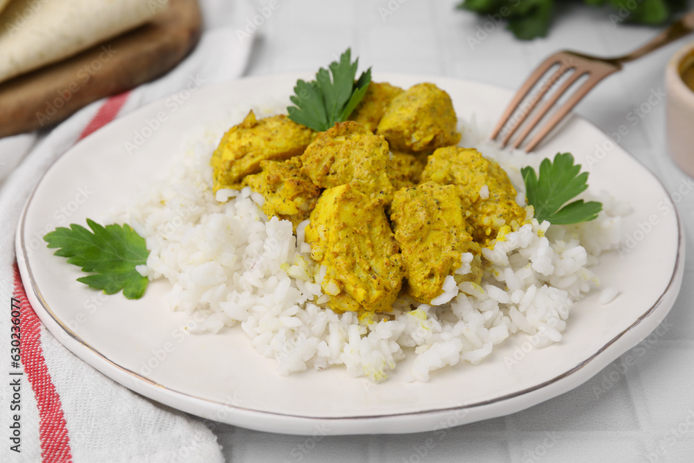 Delicious rice and chicken with curry sauce on white tiled table, closeup Delicious rice and chicken with curry sauce on white tiled table, closeup