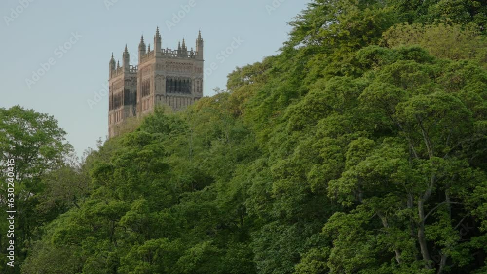 Long clip of the towers of Durham Cathedral framed by trees on a beautiful spring evening. Long clip of the towers of Durham Cathedral framed by trees on a beautiful spring evening.