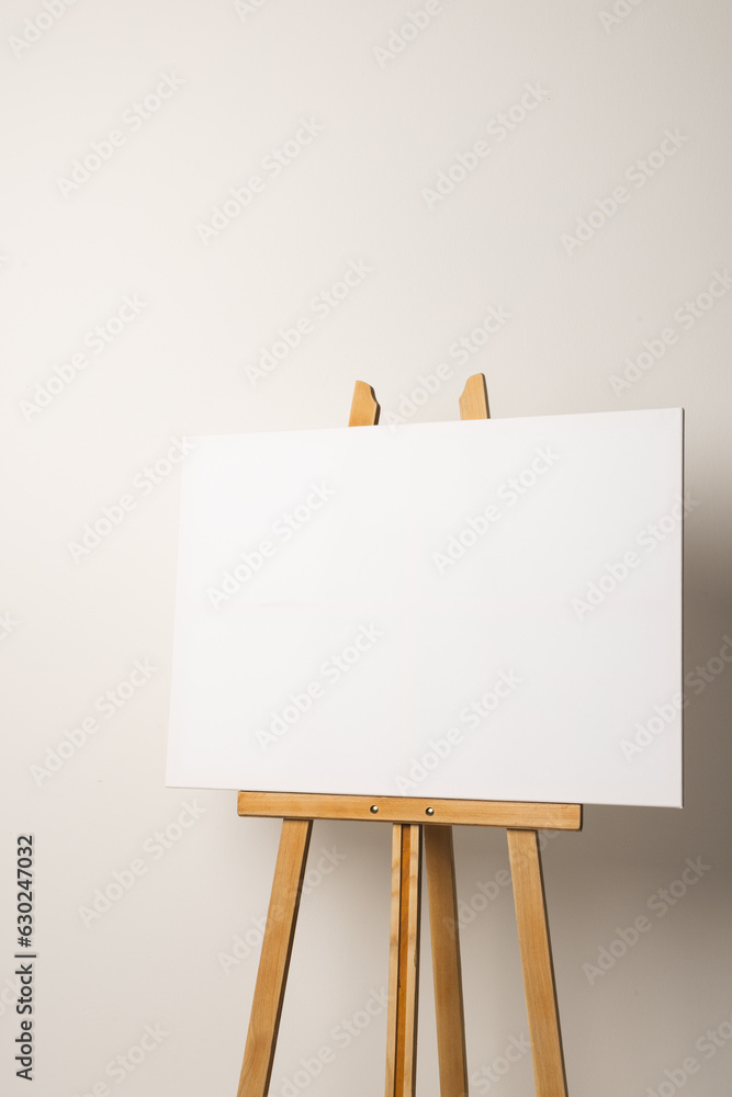 White canvas on wooden easel and copy space on white background White canvas on wooden easel and copy space on white background
