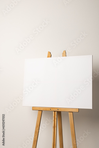 White canvas on wooden easel and copy space on white background