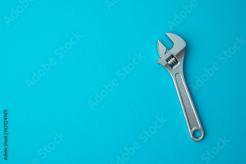 Принти на полотні Chrome adjustable wrench on blue background copy space