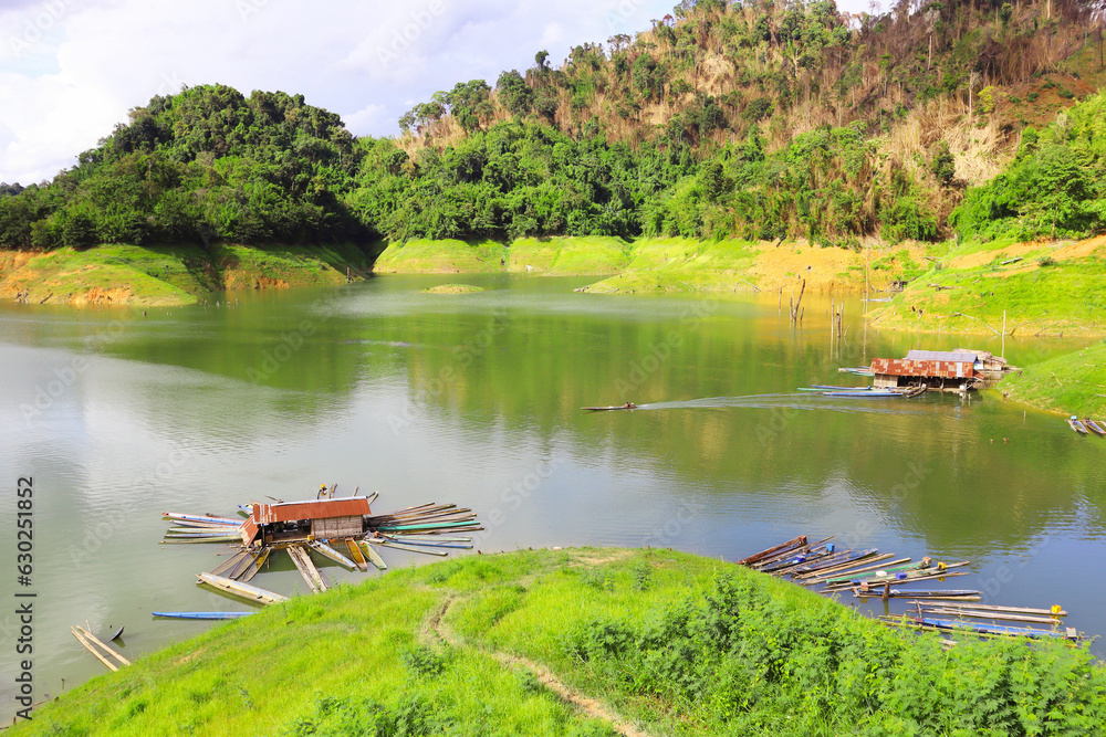 Fototapeta premium Landscape view of the lake with the Abandoned fishing boats and mountain at Muang Fuang, Laos. 